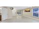 Open concept living room with tile floors, a front door entrance and natural light streaming through windows at 9517 Brackin St, Orlando, FL 32825