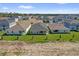 Aerial view of a new construction neighborhood, showcasing similar single-Gathering homes with green lawns at 1792 Aurora Oak Ln, Sanford, FL 32771