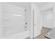 Bathroom featuring a shower/tub combination with a white tile surround and a neutral color scheme at 1792 Aurora Oak Ln, Sanford, FL 32771