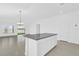 Modern kitchen featuring a large granite island, recessed lighting, and open access to living space at 1792 Aurora Oak Ln, Sanford, FL 32771