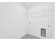 A laundry room features tile flooring, white walls, washer/dryer hookups and a wire shelving unit at 1792 Aurora Oak Ln, Sanford, FL 32771