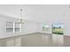 Bright living room with neutral walls, tile flooring, and natural light from the large windows and sliding glass door at 1792 Aurora Oak Ln, Sanford, FL 32771