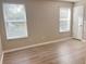 Bright bedroom with laminate flooring, neutral paint and two windows at 2708 Smithfield Dr, Orlando, FL 32837
