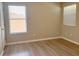 Bright bedroom with laminate flooring, neutral paint and two windows at 2708 Smithfield Dr, Orlando, FL 32837