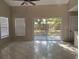 Bright living room features tile floors, neutral paint and sliding glass doors to a patio at 2708 Smithfield Dr, Orlando, FL 32837