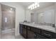 Bathroom with double vanity, granite countertops, and shower at 7420 Oakmoss Loop, Davenport, FL 33837