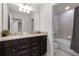 Bathroom with a double vanity, granite countertop, and large mirror at 7420 Oakmoss Loop, Davenport, FL 33837