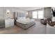 Main bedroom with plush bed, large windows and a sitting area at 7420 Oakmoss Loop, Davenport, FL 33837