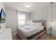 Bedroom with a queen bed, TV, and modern decor at 7420 Oakmoss Loop, Davenport, FL 33837