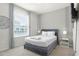 Bright bedroom with a double bed, TV, and ample natural light at 7420 Oakmoss Loop, Davenport, FL 33837