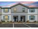 Townhouse with blue shutters and a well maintained lawn and property at 7420 Oakmoss Loop, Davenport, FL 33837