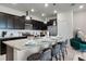 Granite kitchen island with seating for four, dark cabinets at 7420 Oakmoss Loop, Davenport, FL 33837