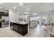 Modern kitchen with island, stainless steel appliances, and granite counters at 7420 Oakmoss Loop, Davenport, FL 33837