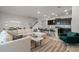 Open living room with L-shaped sofa, and kitchen island at 7420 Oakmoss Loop, Davenport, FL 33837