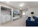 Loft area with sofa, TV, and laundry closet at 7420 Oakmoss Loop, Davenport, FL 33837