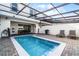 Private pool with patio furniture, grill, and covered lanai at 7420 Oakmoss Loop, Davenport, FL 33837