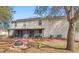 Home's backyard featuring a screened in porch, fire pit, exterior building and mature trees at 800 Daybreak Dr, Fruitland Park, FL 34731