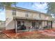 Home's backyard featuring a screened in porch, mulch ground covering, and mature trees at 800 Daybreak Dr, Fruitland Park, FL 34731