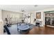 Exercise room with work out equipment, dark wood floors, a laundry room and ceiling fan at 800 Daybreak Dr, Fruitland Park, FL 34731