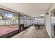 Screened porch with a view, including outdoor furniture and light wood flooring at 800 Daybreak Dr, Fruitland Park, FL 34731