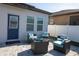 Back patio boasts elegant seating with a privacy fence at 881 Orchid Grove Blvd, Davenport, FL 33837