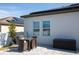 Charming back patio with brick pavers, modern outdoor seating, and a privacy fence at 881 Orchid Grove Blvd, Davenport, FL 33837