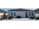 Charming back patio with brick pavers, modern outdoor seating, and a privacy fence at 881 Orchid Grove Blvd, Davenport, FL 33837