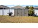 Spacious backyard featuring outdoor storage shed, grill and expansive green space at 881 Orchid Grove Blvd, Davenport, FL 33837