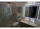 An updated bathroom features a glass-enclosed shower, a modern lighted mirror, and stylish fixtures at 881 Orchid Grove Blvd, Davenport, FL 33837