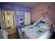 A bedroom features a fun, colorful theme with personalized touches and ample natural light at 881 Orchid Grove Blvd, Davenport, FL 33837
