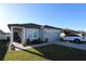 Charming single-Gathering home with well-maintained lawn, covered entry, and attached two-car garage at 881 Orchid Grove Blvd, Davenport, FL 33837