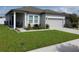 Inviting one-story home features a manicured lawn and lovely curb appeal at 881 Orchid Grove Blvd, Davenport, FL 33837