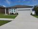 Charming one-story home with a well-manicured lawn and a two car garage at 881 Orchid Grove Blvd, Davenport, FL 33837