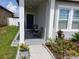Cozy front porch with seating and a charming wreath on the front door at 881 Orchid Grove Blvd, Davenport, FL 33837