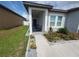 Charming front porch features seating, attractive landscaping, and a welcoming entrance at 881 Orchid Grove Blvd, Davenport, FL 33837