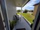 Front porch with seating overlooks the grassy lawn and quiet neighborhood at 881 Orchid Grove Blvd, Davenport, FL 33837
