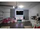 Converted garage features a modern entertainment center, stylish decor, and durable flooring at 881 Orchid Grove Blvd, Davenport, FL 33837