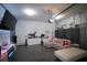 Finished garage featuring updated flooring, modern wall design, and contemporary lighting at 881 Orchid Grove Blvd, Davenport, FL 33837