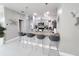 A contemporary kitchen with gray cabinets, stainless appliances, granite countertops, an island with seating, and modern lighting at 881 Orchid Grove Blvd, Davenport, FL 33837