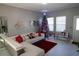 Bright living room with tile flooring, a comfortable sofa, and large windows for natural light at 881 Orchid Grove Blvd, Davenport, FL 33837