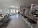 Open-concept living space featuring a breakfast bar, dining area, and comfortable living room at 881 Orchid Grove Blvd, Davenport, FL 33837