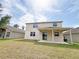 A view of the backyard, patio, and the exterior of the house at 1208 Sawgrass Pointe Dr, Orlando, FL 32824