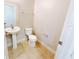 Compact half-bathroom with a pedestal sink and toilet, providing convenience for guests and daily use at 1208 Sawgrass Pointe Dr, Orlando, FL 32824