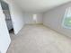 Carpeted bonus room with attached hallway, stairwell, and natural light at 1208 Sawgrass Pointe Dr, Orlando, FL 32824