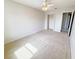 A bedroom with neutral carpeting, ceiling fan and a walk-in closet at 1208 Sawgrass Pointe Dr, Orlando, FL 32824