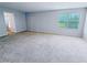 Carpeted bedroom with natural light and bathroom entrance at 1208 Sawgrass Pointe Dr, Orlando, FL 32824