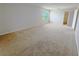 Spacious bedroom with neutral carpet, a window, and an open closet area at 1208 Sawgrass Pointe Dr, Orlando, FL 32824