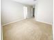 A bright bedroom with neutral carpeting, beige walls, and a walk-in closet at 1208 Sawgrass Pointe Dr, Orlando, FL 32824