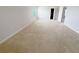 Bright bedroom featuring neutral carpet, ample natural light, and a closet at 1208 Sawgrass Pointe Dr, Orlando, FL 32824