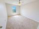 A bright bedroom with neutral carpeting, ceiling fan and a view of the window at 1208 Sawgrass Pointe Dr, Orlando, FL 32824